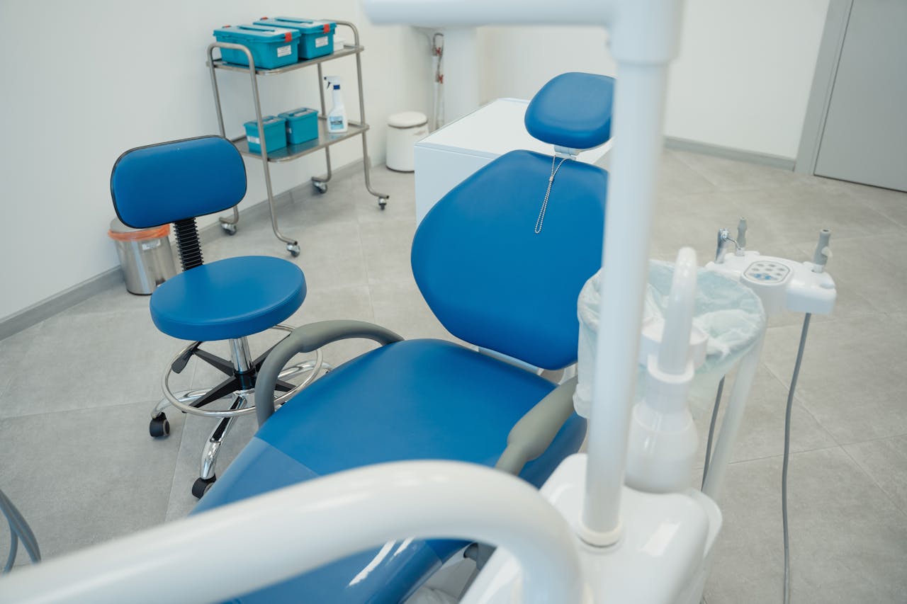 A clean and modern dental clinic featuring blue chairs and essential dental equipment.