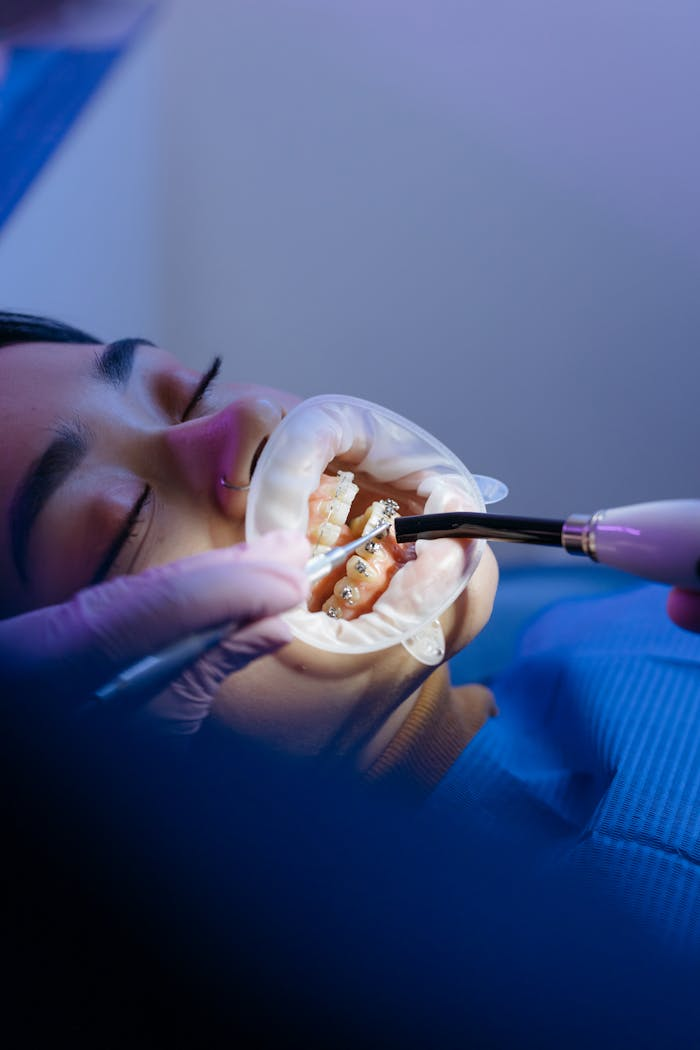 Patient receiving orthodontic treatment in a modern dental clinic, showcasing dental care techniques.